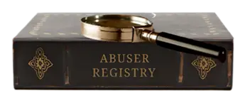 Leather book and spyglass with the words "abuser registry" on the spine of the book